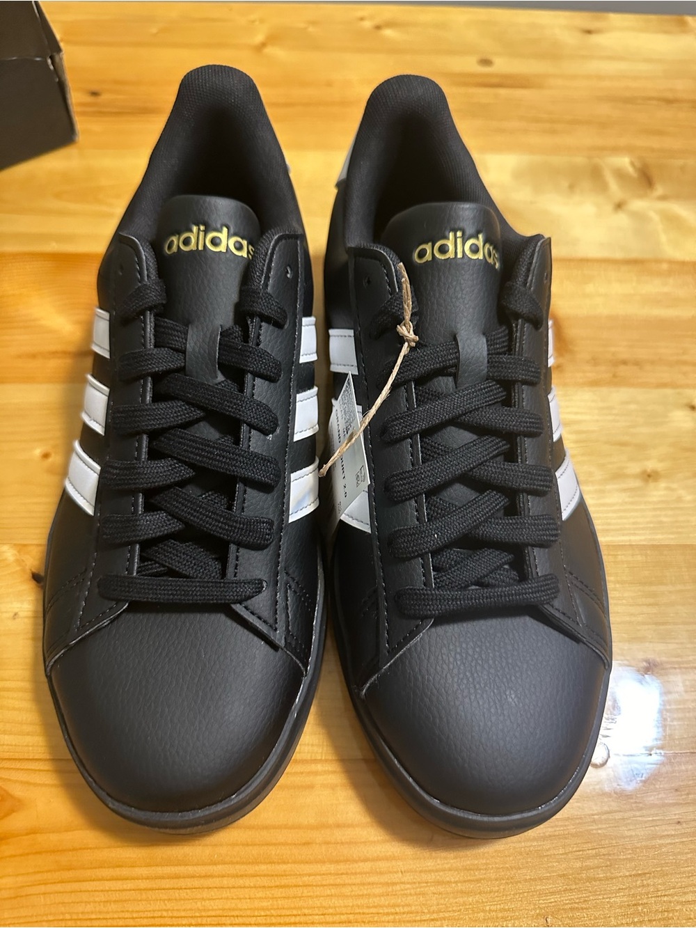 adidas Black Sneakers with White Stripes and Gold Branding